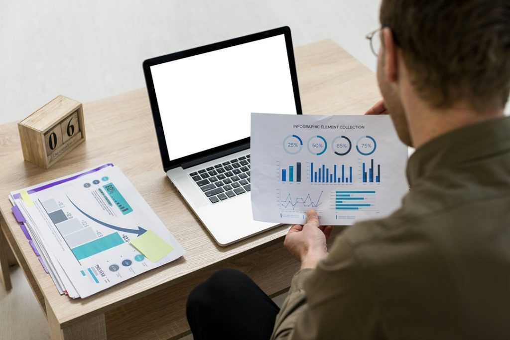 Man Checking The Reports About The Latest Research And Studies In SEO